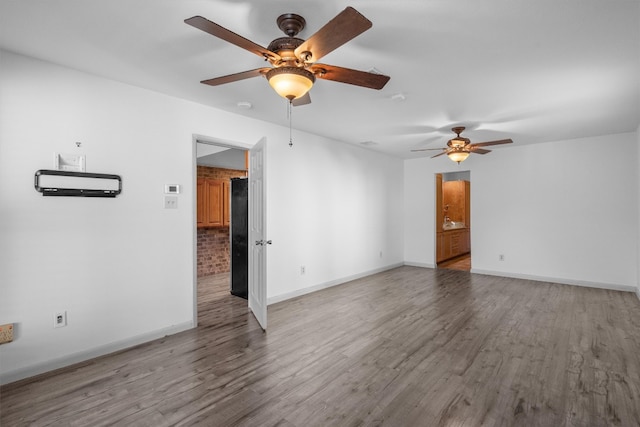 spare room featuring hardwood / wood-style flooring and ceiling fan