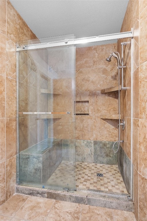 bathroom featuring a textured ceiling and an enclosed shower