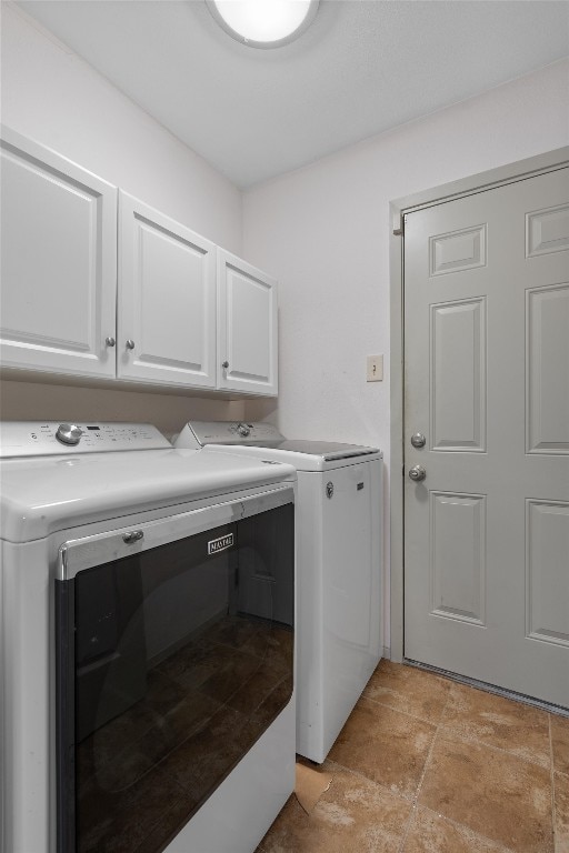 laundry room featuring cabinets and washing machine and dryer