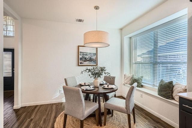 dining space featuring dark hardwood / wood-style flooring and plenty of natural light