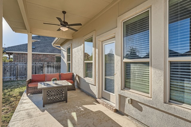 view of patio / terrace featuring ceiling fan and an outdoor living space with a fire pit