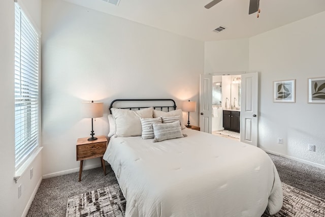 bedroom with ceiling fan, carpet floors, and ensuite bathroom