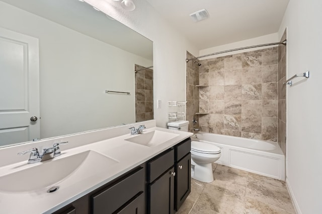 full bathroom featuring toilet, vanity, and tiled shower / bath