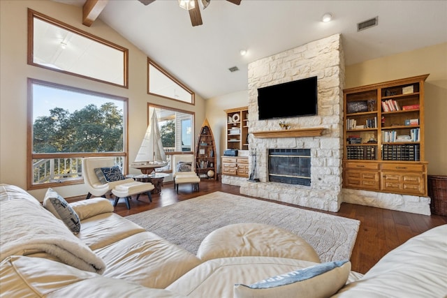 living room with dark hardwood / wood-style floors, ceiling fan, a stone fireplace, and high vaulted ceiling