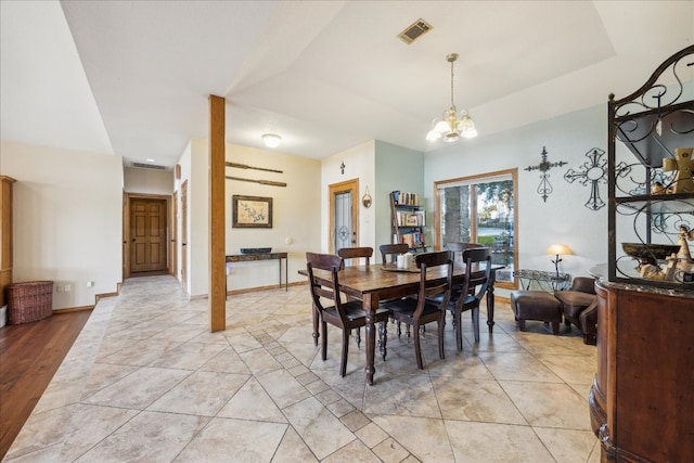 dining area with a chandelier and light wood-type flooring