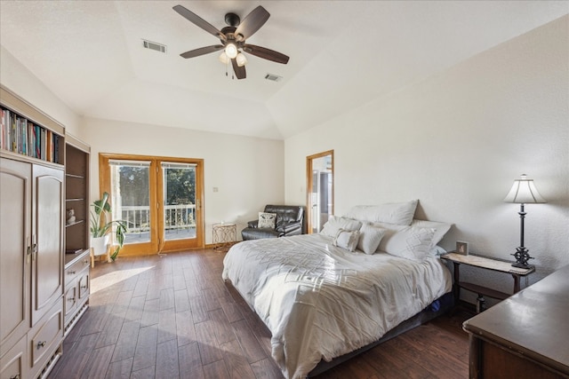 bedroom with vaulted ceiling, ceiling fan, dark hardwood / wood-style floors, access to exterior, and a tray ceiling