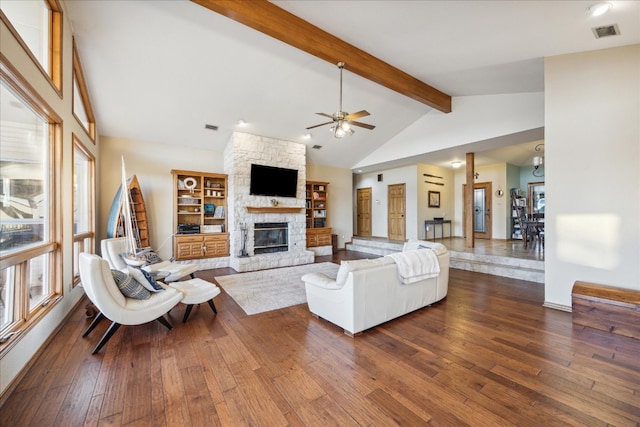 living room with beam ceiling, dark hardwood / wood-style flooring, and plenty of natural light