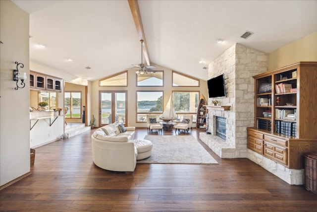 living room with ceiling fan, beam ceiling, dark hardwood / wood-style flooring, and a fireplace