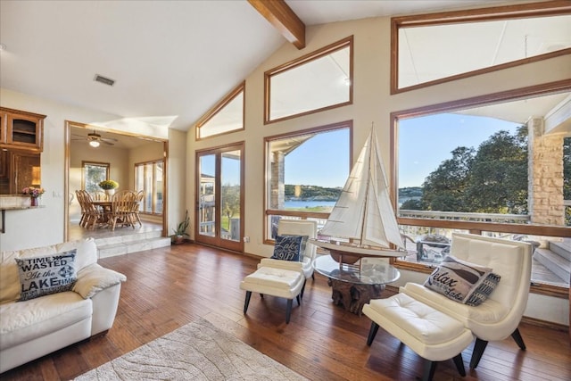 living room featuring beamed ceiling, visible vents, wood-type flooring, and high vaulted ceiling