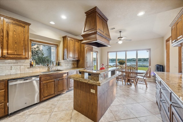 kitchen featuring light stone countertops, tasteful backsplash, ceiling fan, sink, and dishwasher