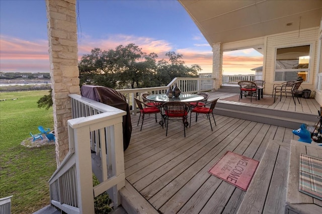 20625 Highland Lake Loop, Lago Vista, TX 78645 - deck at dusk with outdoor dining area and a lawn