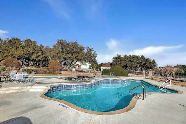 view of swimming pool with a patio area