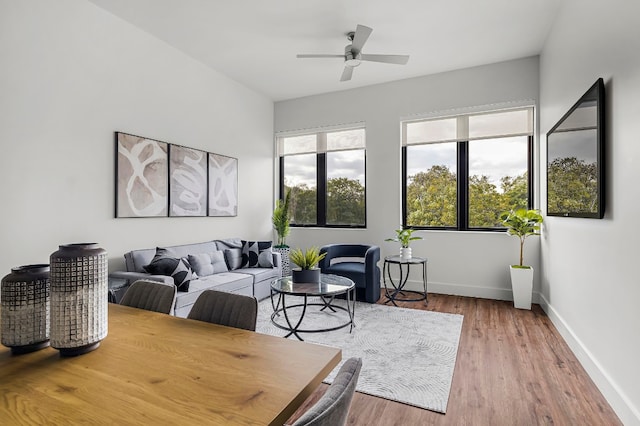 living room featuring wood-type flooring and ceiling fan