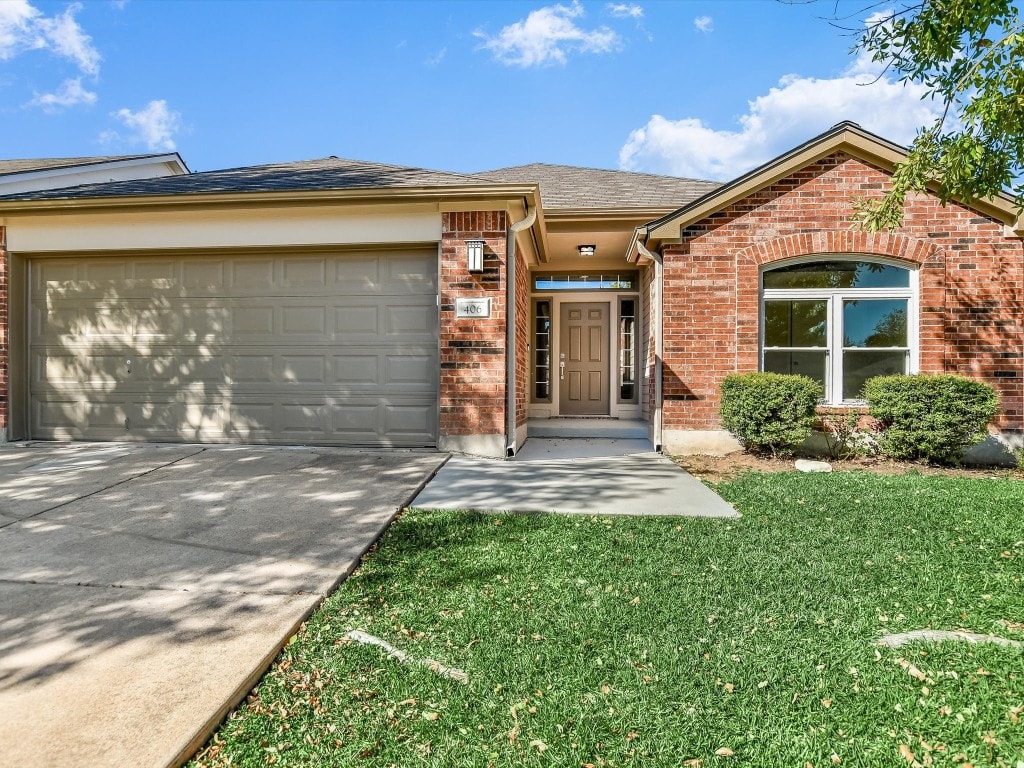 view of front of house with a garage and a front lawn