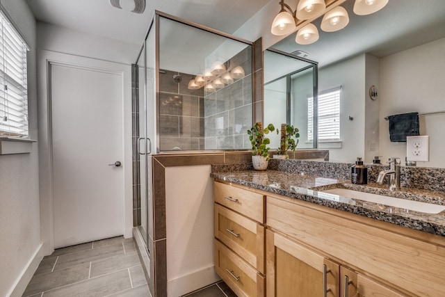 bathroom featuring vanity and an enclosed shower