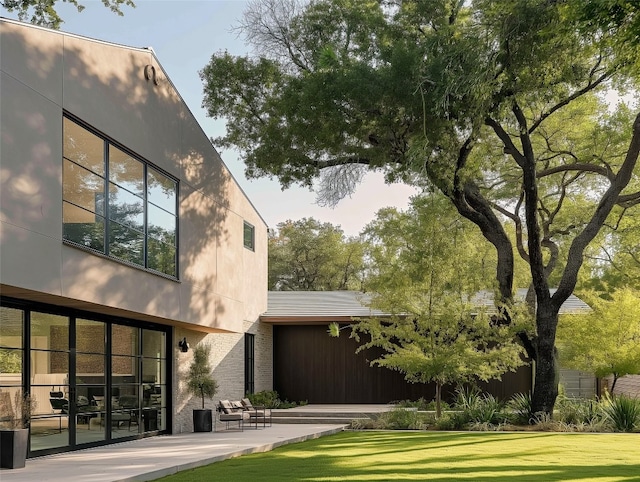 back of house featuring a yard and a patio area