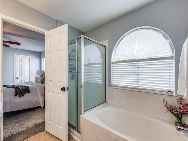 108 Killian Loop, Hutto, TX 78634 - ensuite bathroom featuring a garden tub, a stall shower, and tile patterned flooring