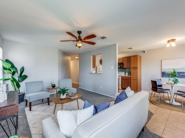 108 Killian Loop, Hutto, TX 78634 - living area with ceiling fan, baseboards, and light tile patterned flooring