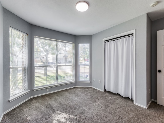 unfurnished bedroom with baseboards and carpet