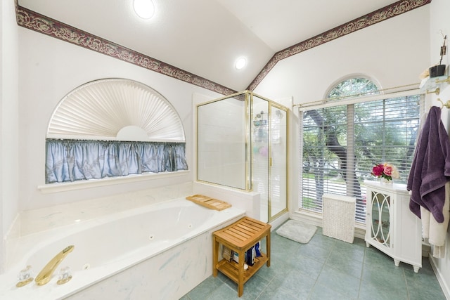 bathroom with tile patterned floors, separate shower and tub, and vaulted ceiling