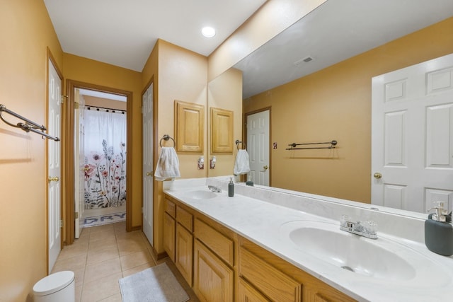 bathroom featuring tile patterned flooring and vanity