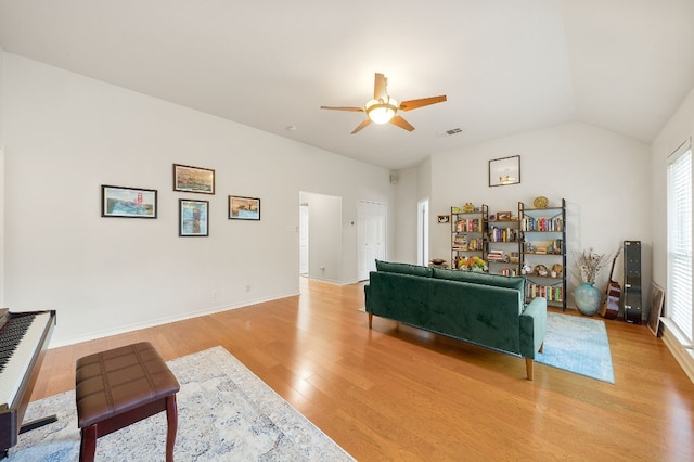 living room with lofted ceiling, a healthy amount of sunlight, light hardwood / wood-style floors, and ceiling fan