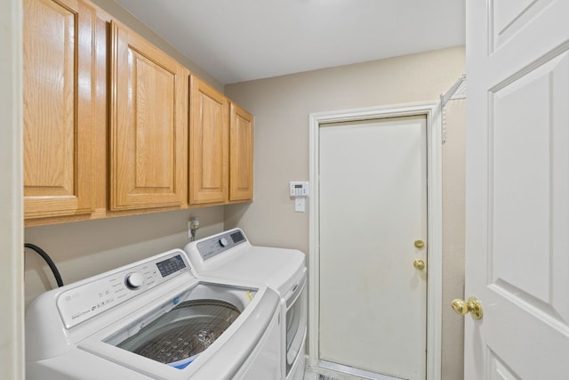 laundry area with cabinets and independent washer and dryer