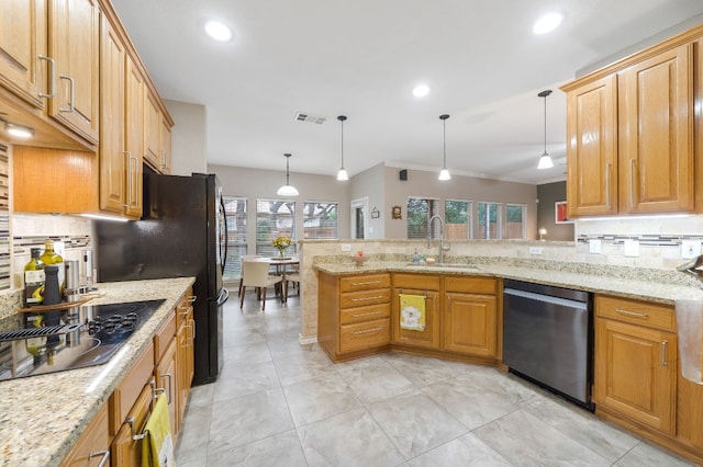 kitchen featuring hanging light fixtures, dishwasher, a healthy amount of sunlight, and sink