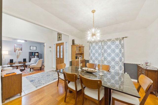 dining space with an inviting chandelier and light hardwood / wood-style flooring