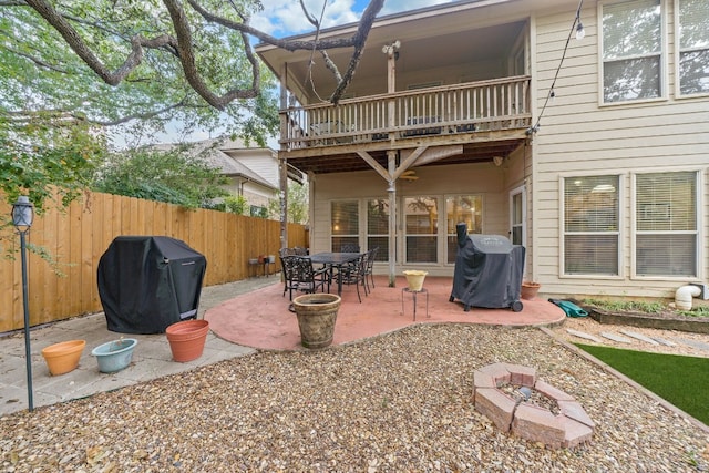 back of house with a patio, a balcony, and an outdoor fire pit