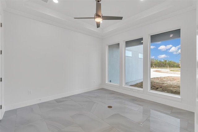 spare room featuring a raised ceiling, crown molding, and ceiling fan