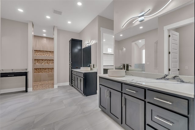 bathroom featuring a shower and vanity