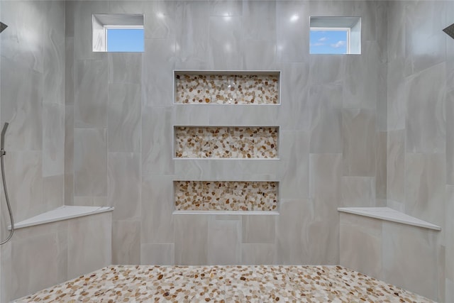 bathroom featuring a tile shower