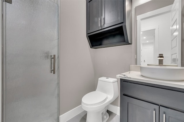 bathroom with tile patterned flooring, a shower with door, vanity, and toilet