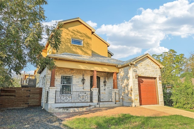 view of front of house with a porch and a garage