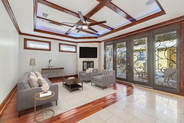 living room featuring coffered ceiling, french doors, ceiling fan, light wood-type flooring, and beamed ceiling