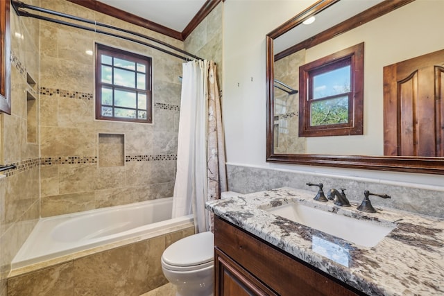 full bathroom with vanity, toilet, ornamental molding, and shower / tub combo