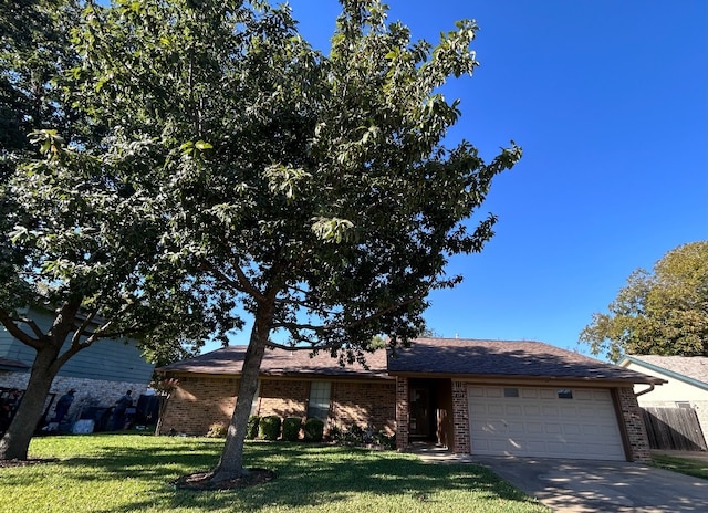 ranch-style home with a garage and a front lawn