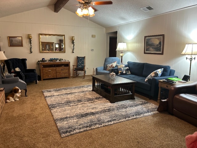 living room with carpet, a textured ceiling, lofted ceiling with beams, and ceiling fan