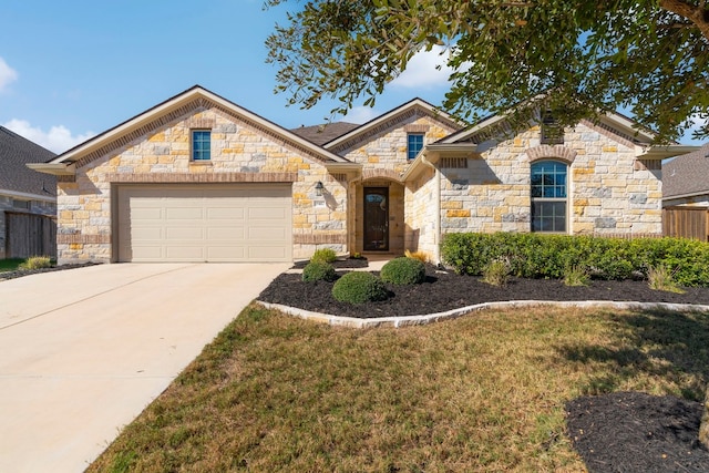 view of front of property with a front yard and a garage