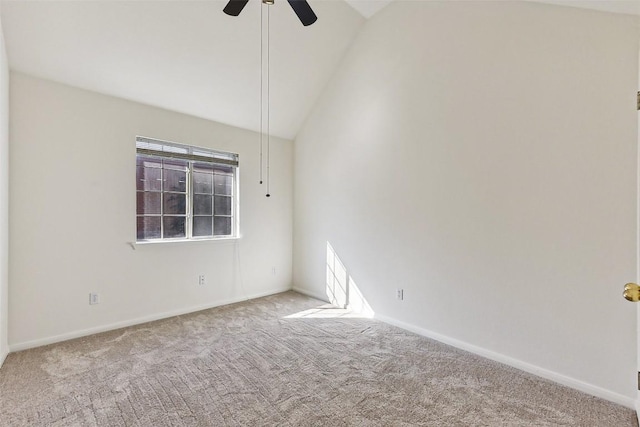 spare room with ceiling fan, light colored carpet, and vaulted ceiling