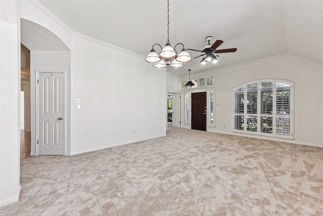 spare room with carpet, ceiling fan with notable chandelier, crown molding, and vaulted ceiling