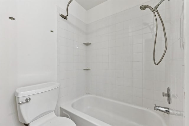 bathroom with tiled shower / bath combo and toilet