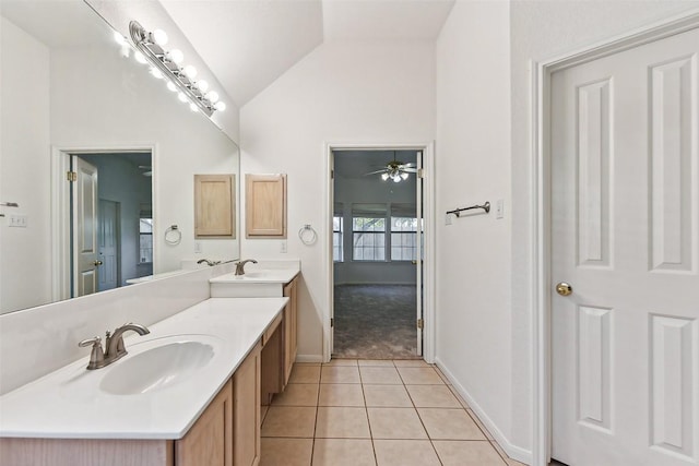 bathroom with tile patterned floors, vanity, vaulted ceiling, and ceiling fan