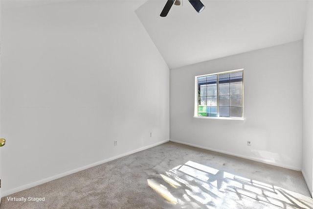 carpeted spare room featuring ceiling fan and lofted ceiling