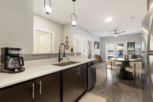 2505 Thornton Rd Unit 1103, Austin, TX 78704 - kitchen featuring a sink, stainless steel dishwasher, concrete floors, light countertops, and pendant lighting