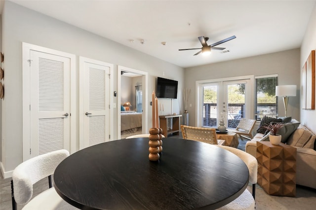 dining space featuring ceiling fan and french doors