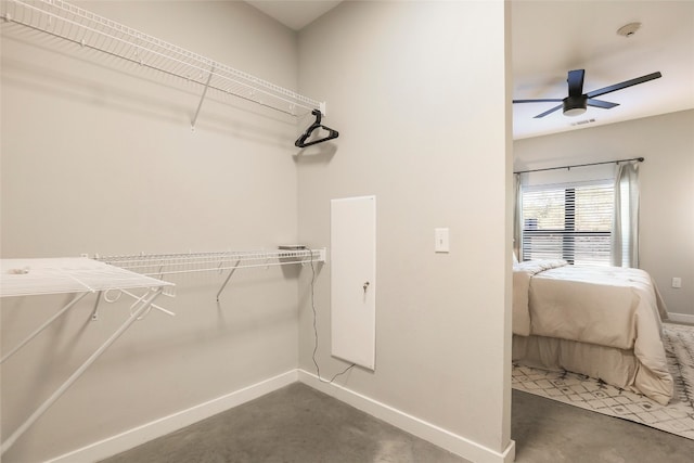 walk in closet with ceiling fan