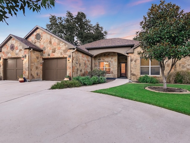 view of front facade with a lawn and a garage