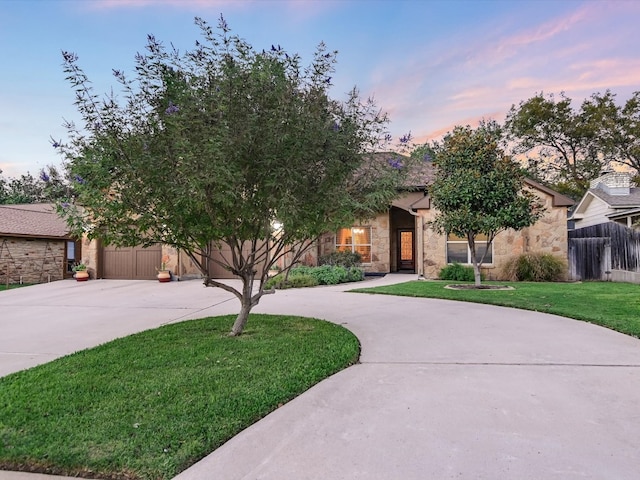 view of property hidden behind natural elements featuring a lawn